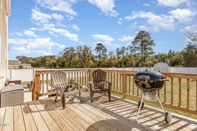 a view of balcony with wooden floor and outdoor seating
