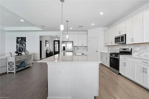 a large white kitchen with a large window