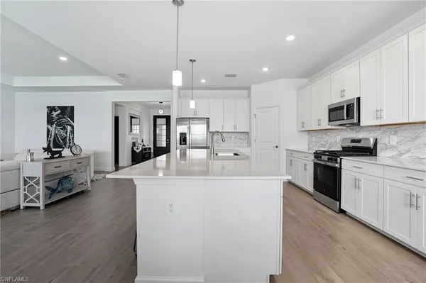 a large white kitchen with a large window