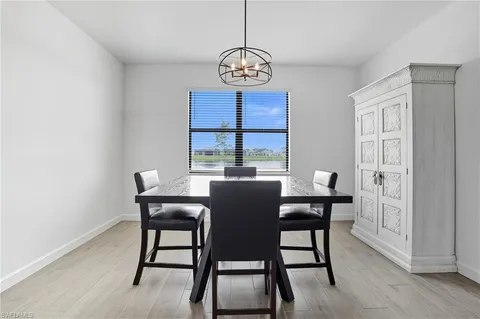 a large white kitchen with kitchen island a sink a center island stainless steel appliances and a center island