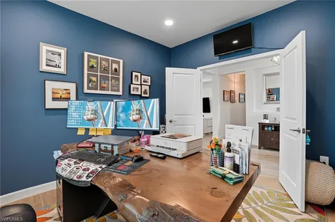 a view of a dining room and livingroom with furniture wooden floor and a rug
