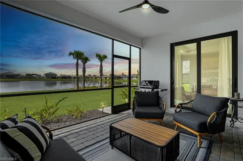 a living room with furniture and a floor to ceiling window