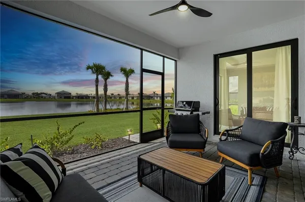 a living room with furniture and a floor to ceiling window