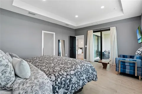 a bedroom with bed chair and window