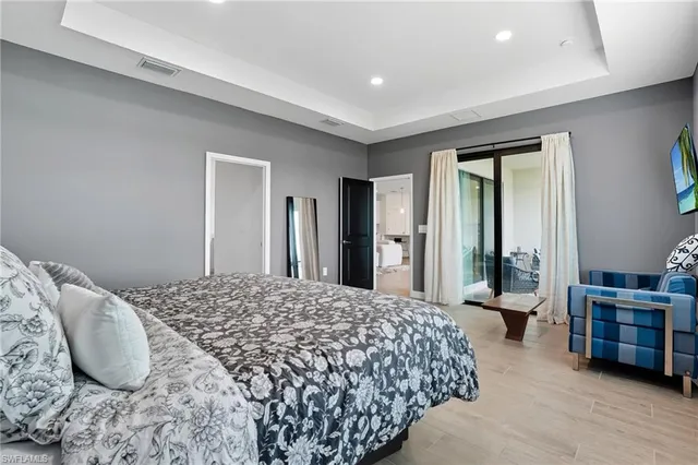 a bedroom with bed chair and window