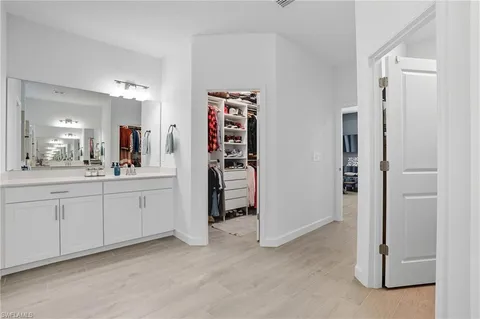 a bathroom with a double vanity sink a toilet and shower