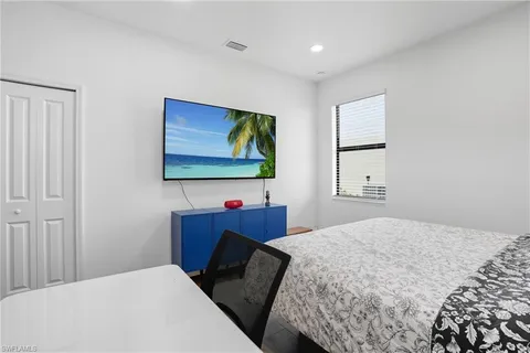 a bedroom with a bed and chair