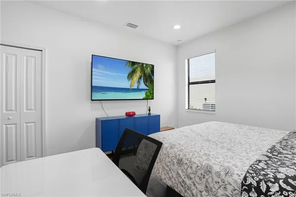 a bedroom with a bed and chair