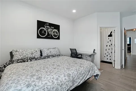 a bedroom with a bed and a painting on the wall