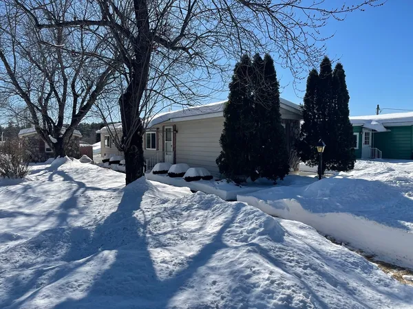 a view of yard covered with snow in front of house