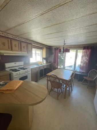 a kitchen with a table chairs and a refrigerator