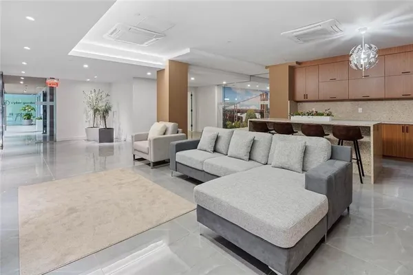 a living room with furniture and a kitchen view