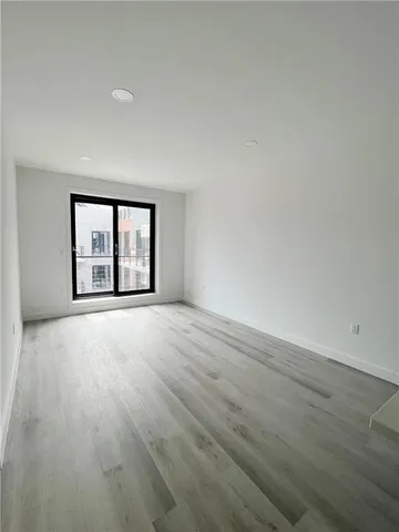 wooden floor and window in an empty room
