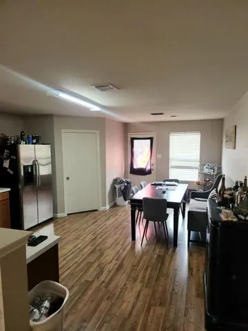 a view of a dining room with furniture and wooden floor