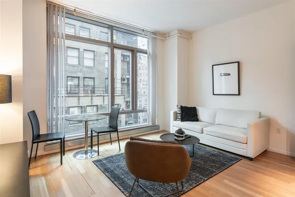 a living room with furniture wooden floor and a table