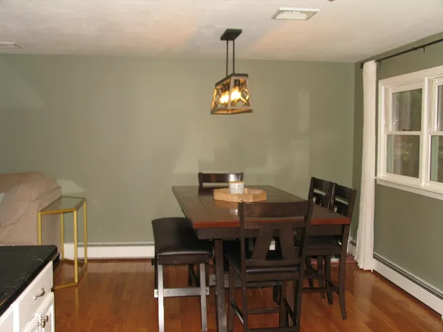 a view of a dining room with furniture wooden floor and chandelier