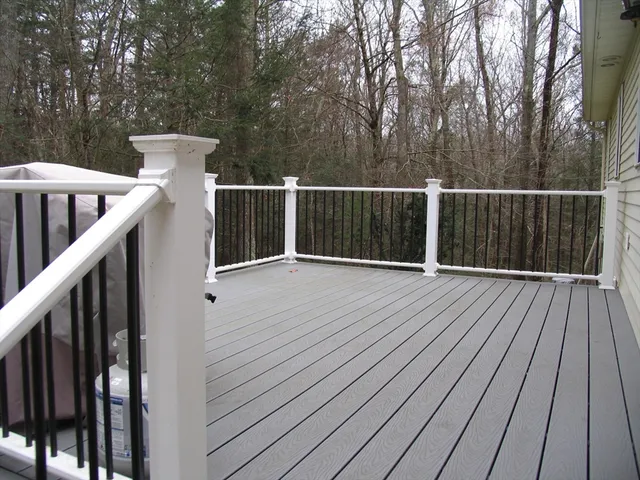 a view of deck with wooden floor and fence