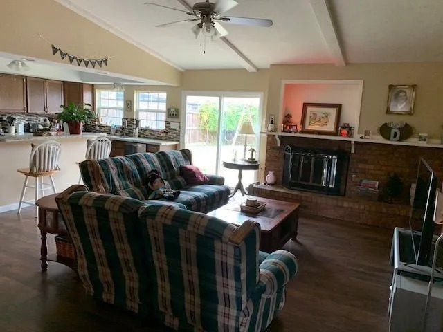 a living room with furniture a fireplace and a flat screen tv