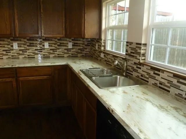 a kitchen with a sink and a window