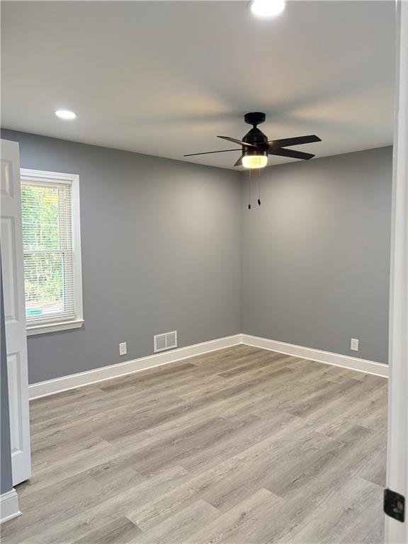 1546 Alverado Way Decatur, GA 30032 - Photo 11 of 17 a view of an empty room with window and wooden floor