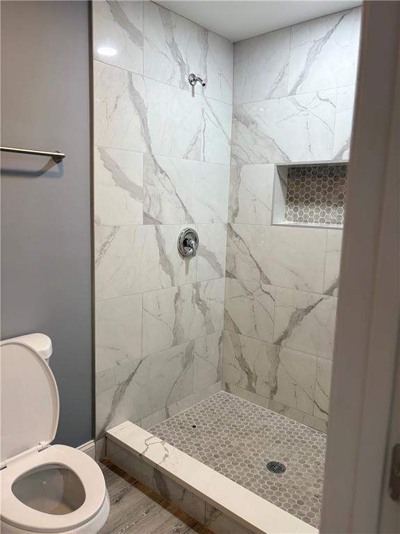 1546 Alverado Way Decatur, GA 30032 - Photo 17 of 17 a bathroom with a granite countertop bathtub shower sink and toilet