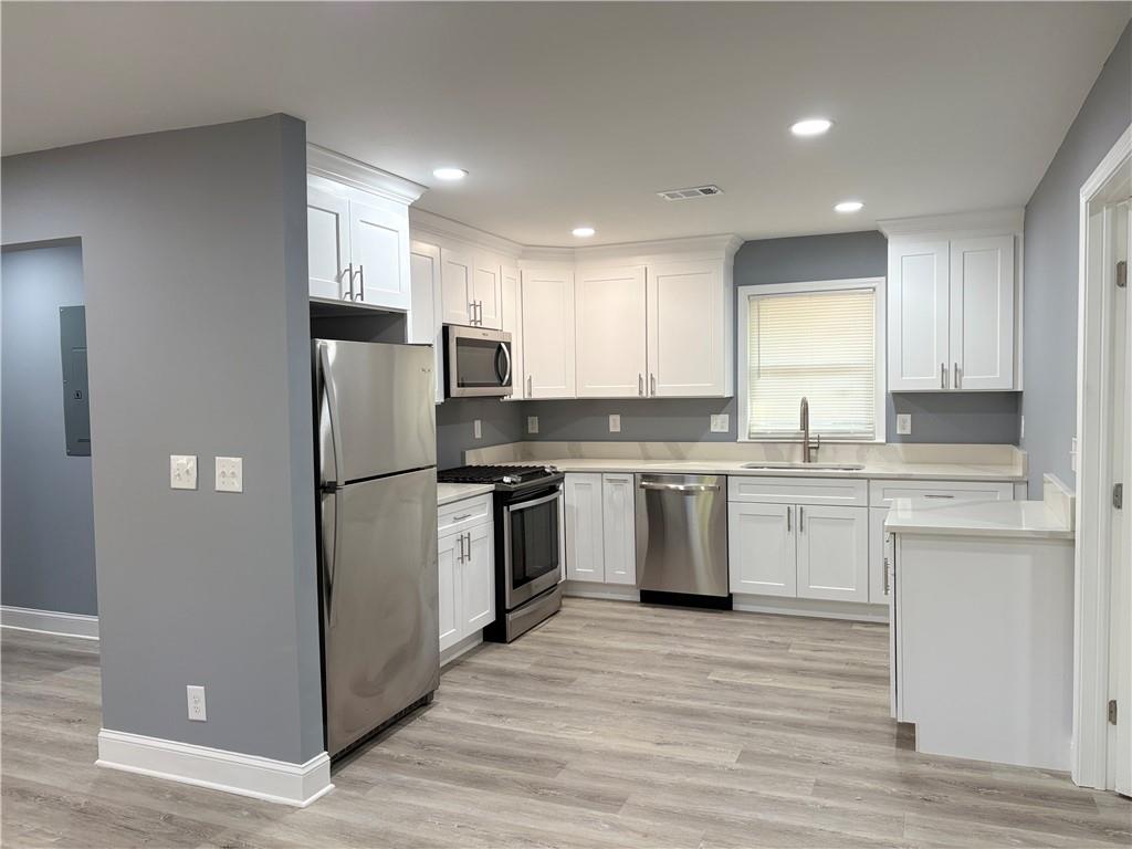 1546 Alverado Way Decatur, GA 30032 - Photo 4 of 17 a kitchen with a refrigerator sink and cabinets