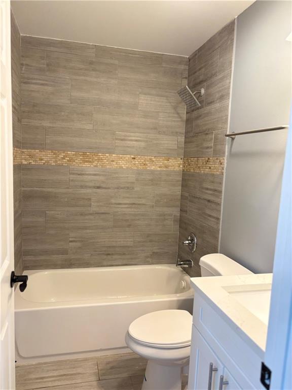 1546 Alverado Way Decatur, GA 30032 - Photo 9 of 17 a bathroom with a granite countertop bathtub shower sink mirror vanity and toilet