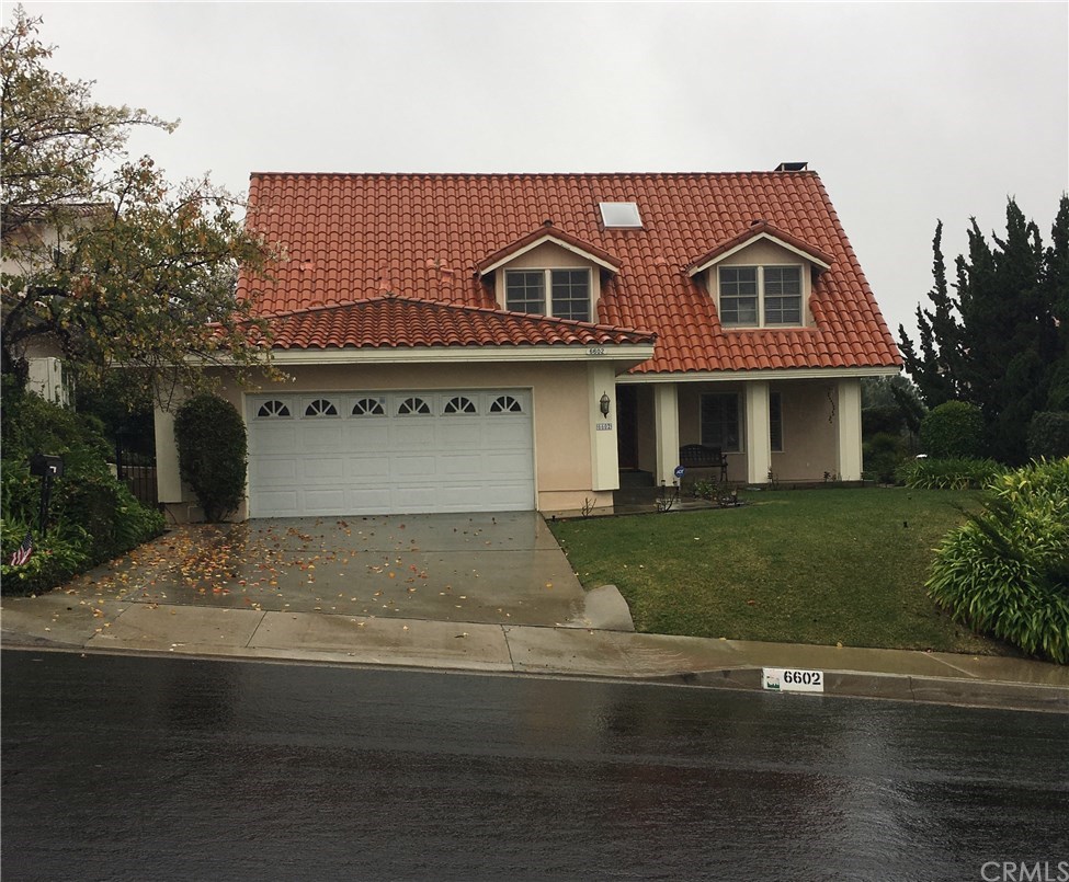 6602 Vee Ridge Road Rancho Palos Verdes, CA 90275 - Photo 1 of 1 a front view of a house with a garden and parking