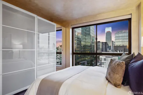 a bedroom with a large bed and a large window