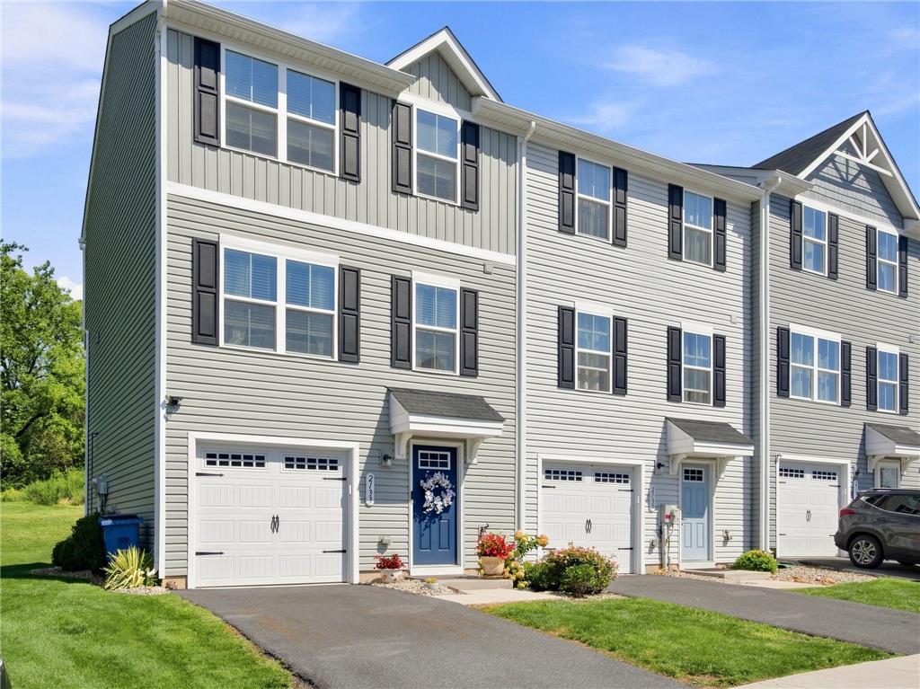 2133 Cross Country Road Northampton, PA 18067 - Photo 3 of 44 A modern multi-level townhouse exterior showcases clean horizontal siding and classic dark shutters.