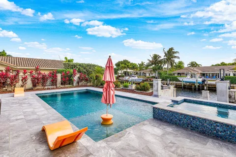 an outdoor sitting area with swimming pool