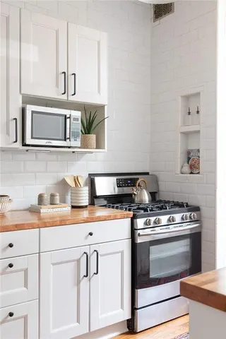 a bedroom with a bed and a potted plant
