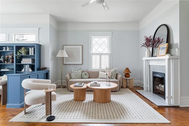 a living room with furniture a rug and a fireplace