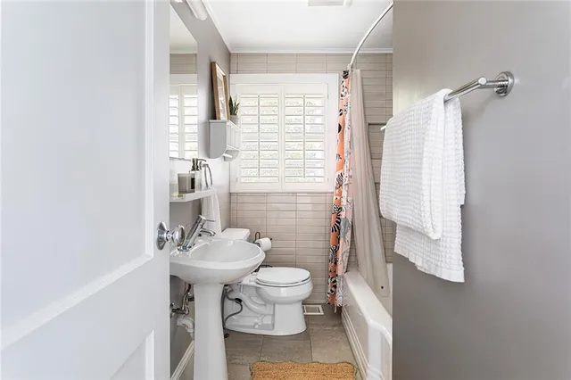 a spacious bedroom with a bed and a potted plant