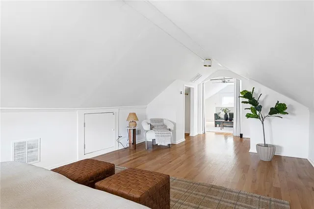 a view of the patio with dining table and chairs under an umbrella