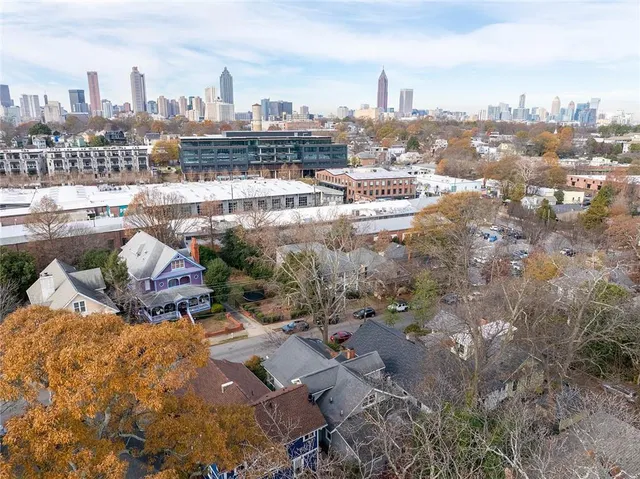 a man sitting on a bench in front of a building