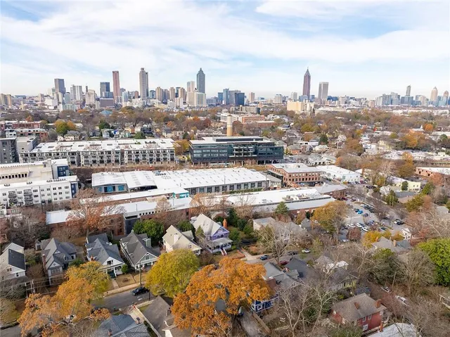 a group of people sitting under an umbrella in front of retail shop
