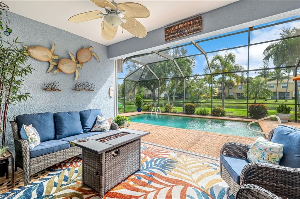 a living room with patio furniture and a floor to ceiling window