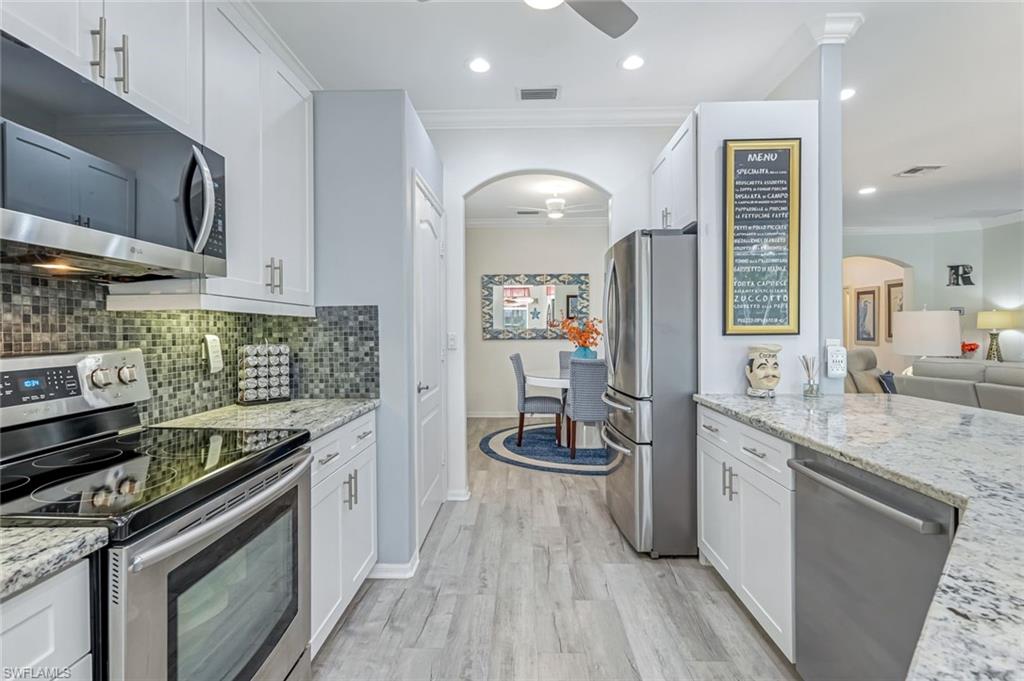 20050 Rookery Drive Estero, FL 33928 - Photo 14 of 45 a kitchen with a stove and a sink