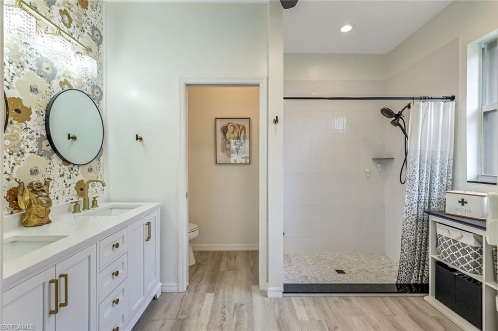 20050 Rookery Drive Estero, FL 33928 - Photo 20 of 45 a bathroom with a sink mirror vanity and toilet
