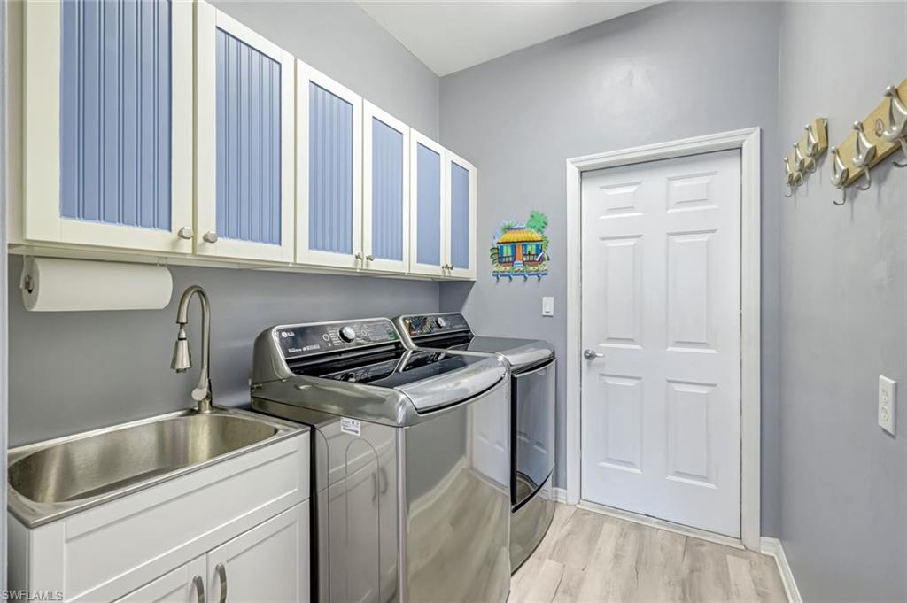 20050 Rookery Drive Estero, FL 33928 - Photo 27 of 45 a kitchen that has a sink and a stove in it