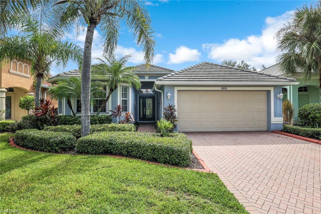 20050 Rookery Drive Estero, FL 33928 - Photo 3 of 45 a front view of house with yard and green space