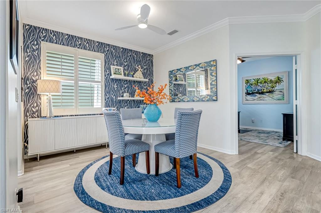 20050 Rookery Drive Estero, FL 33928 - Photo 5 of 45 a view of a dining room with furniture window and wooden floor