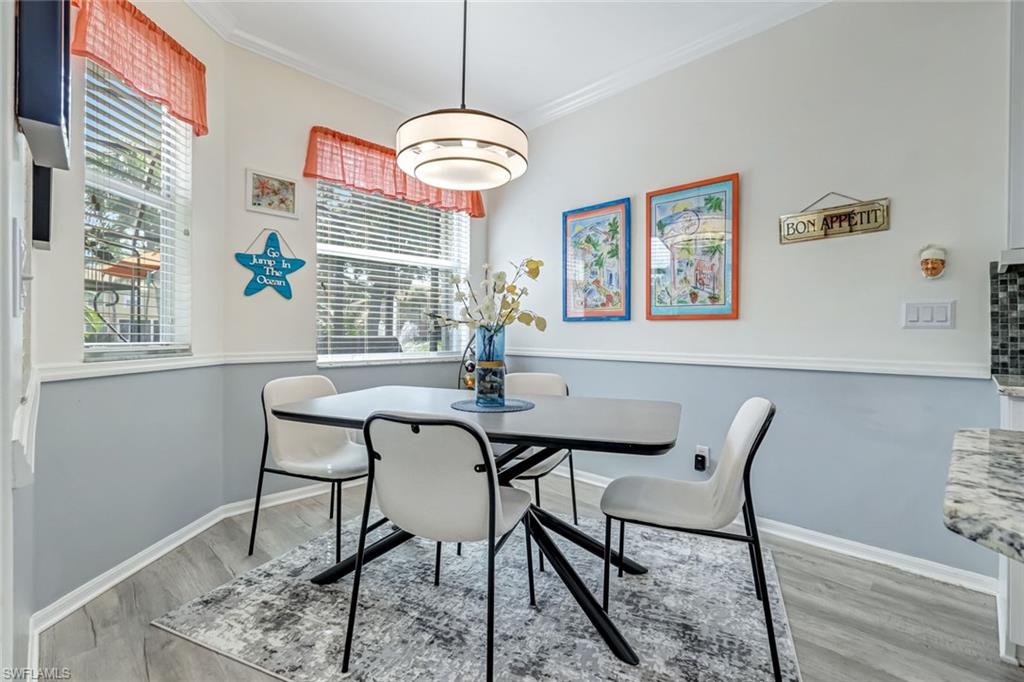 20050 Rookery Drive Estero, FL 33928 - Photo 10 of 45 a view of a dining room with furniture wooden floor and a chandelier