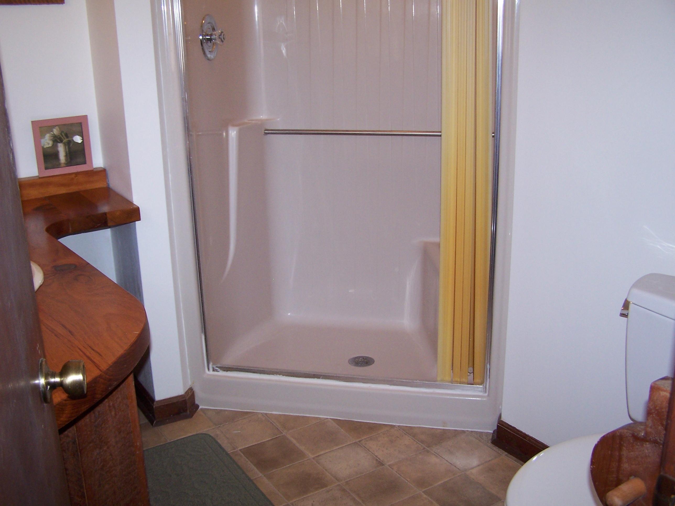 219 W Road Blue Ridge, VA 24064 - Photo 18 of 25 a bathroom with a bathtub and a shower