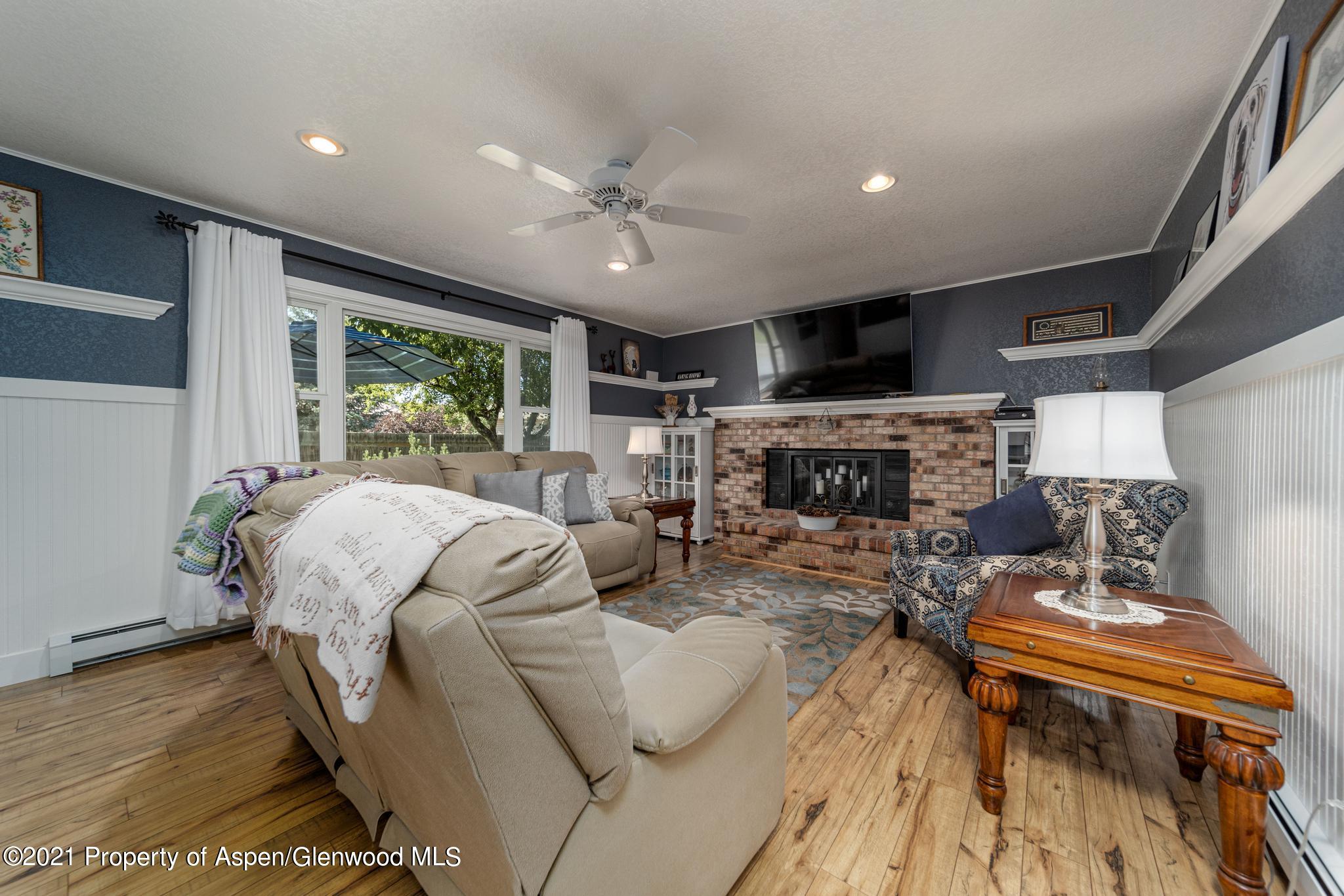 737 Cactus Court Rifle, CO 81650 - Photo 6 of 24 a living room with furniture fireplace and a flat screen tv
