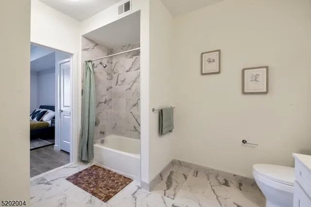 a bathroom with a toilet and a shower