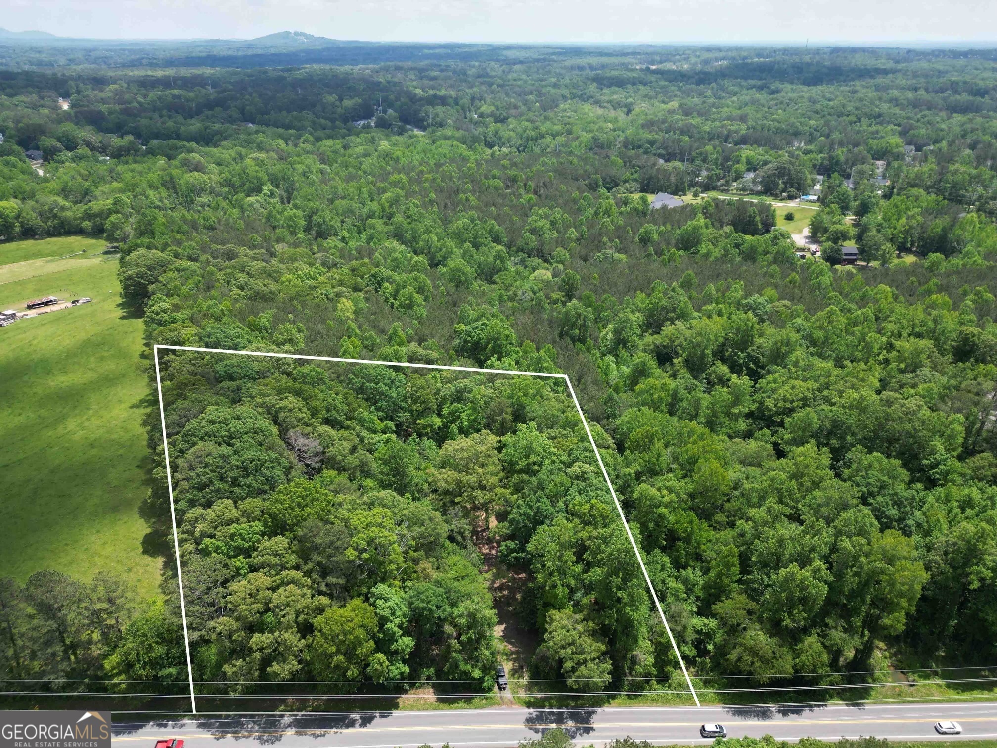 5166 Dallas Acworth Highway Dallas, GA 30132 - Photo 1 of 1 a view of a field of grass and trees