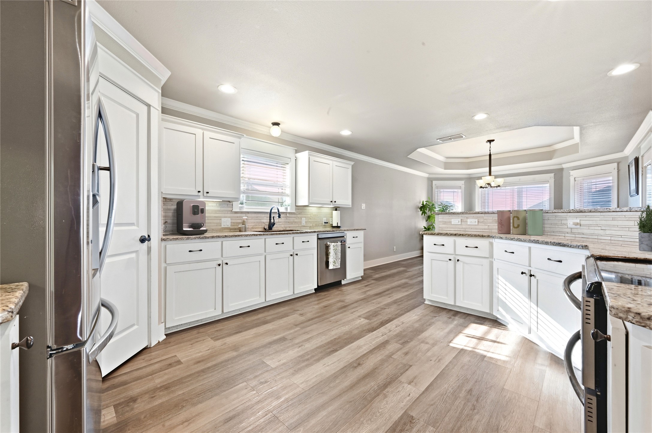 4467 West Amity Road Salado, TX 76571 - Photo 15 of 40 The kitchen features white cabinetry, granite countertops, and a tiled backsplash