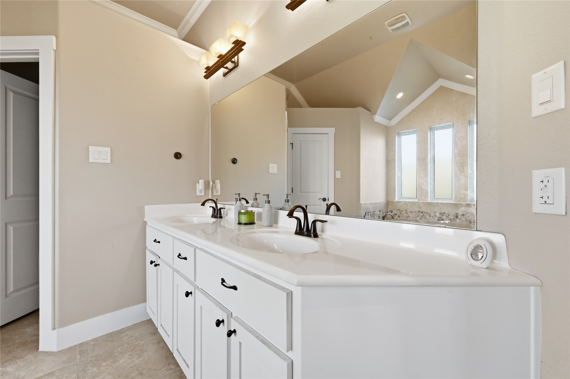 4467 West Amity Road Salado, TX 76571 - Photo 20 of 40 The bathroom features a double vanity with white cabinetry, dark hardware, and a large mirror